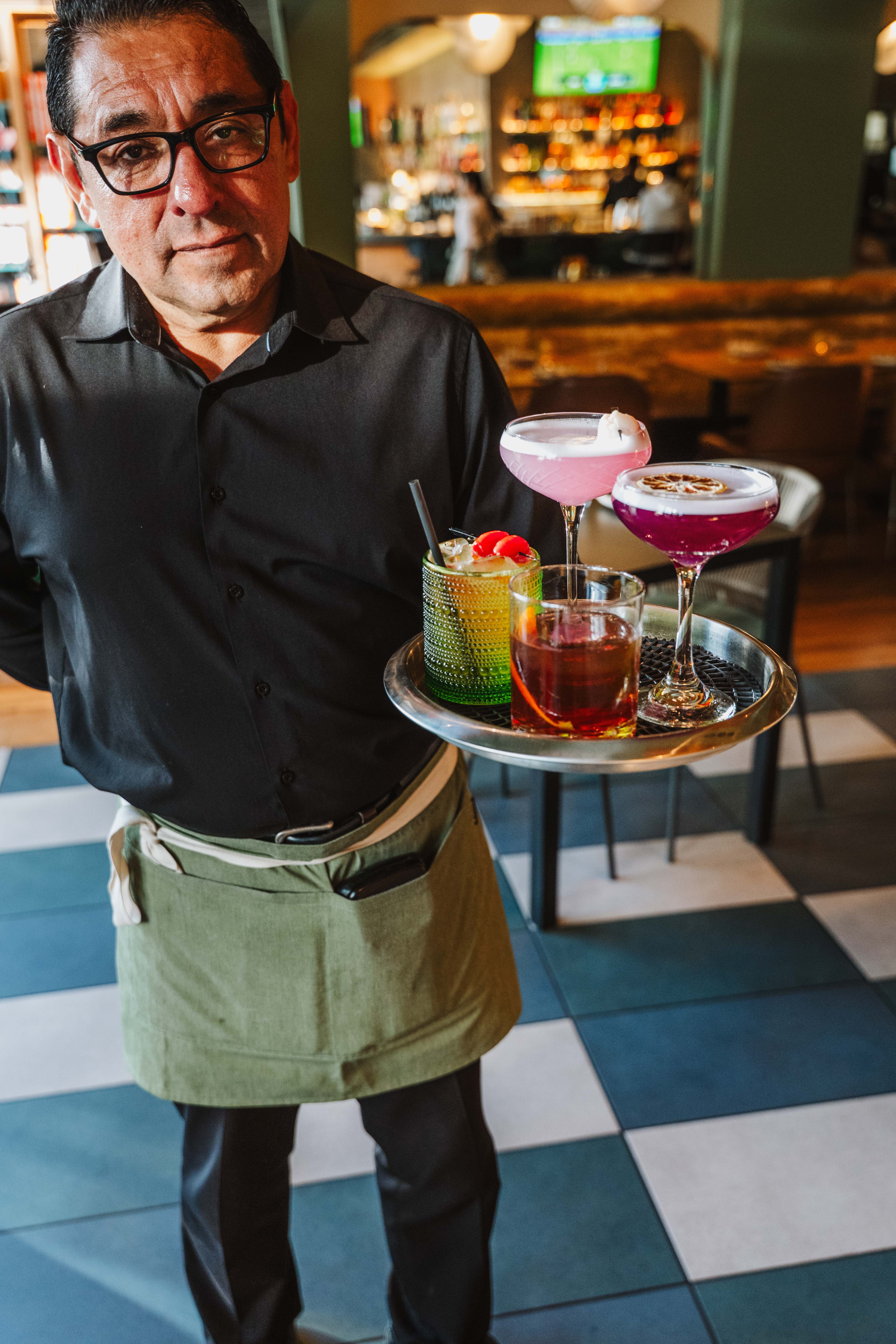Server bringing cocktails at Burma Superstar Oakland